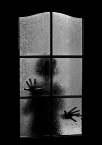 Dark Silhouette Of Girl Behind Glass. Locked Alone In Room Behin