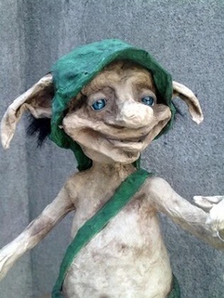 Cute Statue of Chaneques wearing a green hat and bag
