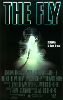 The theatrical poster for The Fly. A dark background surrounds a glowing teleportation pod, its door cracked open with bright green light spilling out. A human hand and forearm reach from inside the pod toward the viewer. At the top, bold white text reads, “BE AFRAID. BE VERY AFRAID.” Below the image is the film’s title, The Fly, followed by production credits.